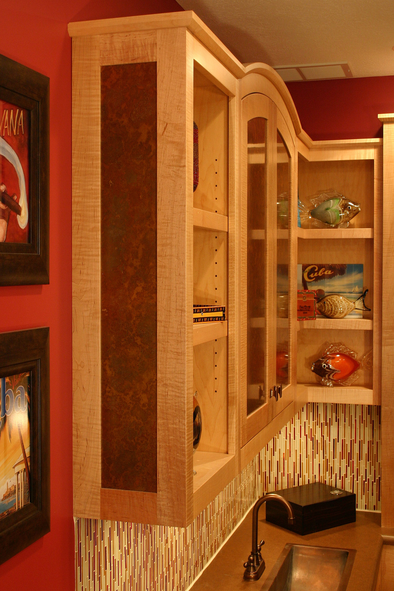Bar cabinetry in curly maple with acid-etched brass panels, built by Trillium for the Geist project