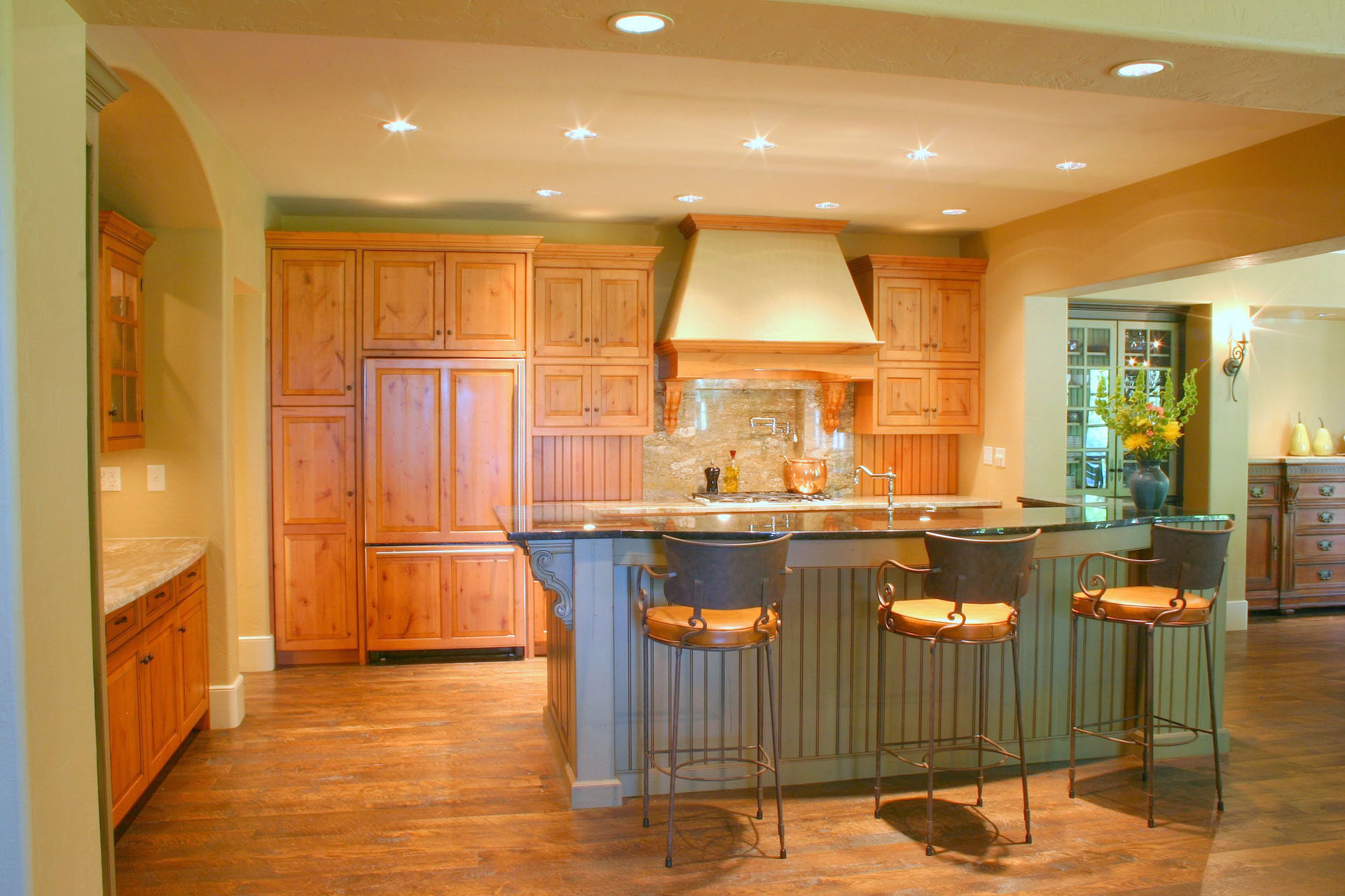 Distressed alder kitchen with a green painted island, built by Trillium for the Limehouse project