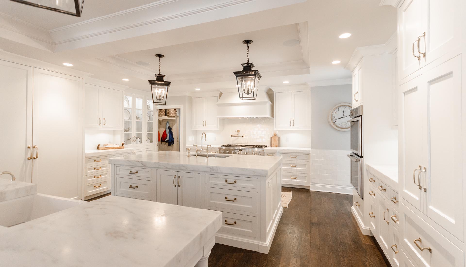 Painted inset kitchen with a marble-topped island, built by Trillium in Williams Creek